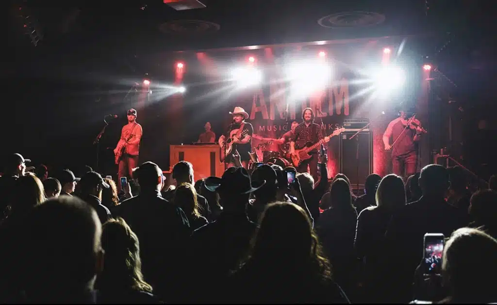 Indoor concert venue with live band performance and stage lighting at Broken Bow cabin rental entertainment space